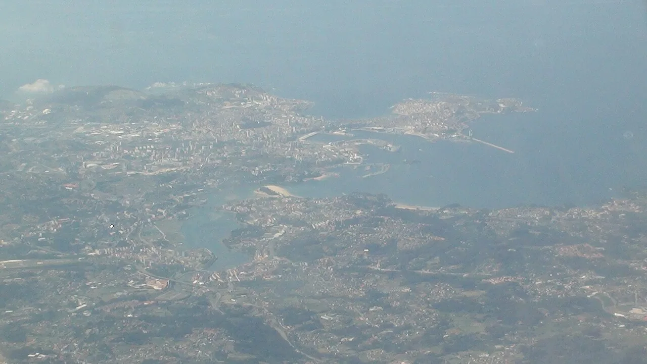 Hazy aerial view of A Coruña and its ría from an aircraft.