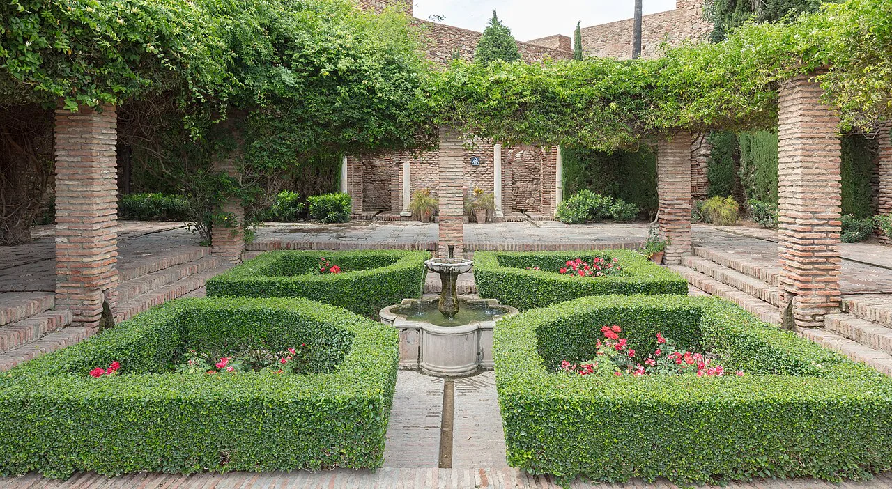 Garden courtyard with a fountain inside the Alcazaba of Málaga.