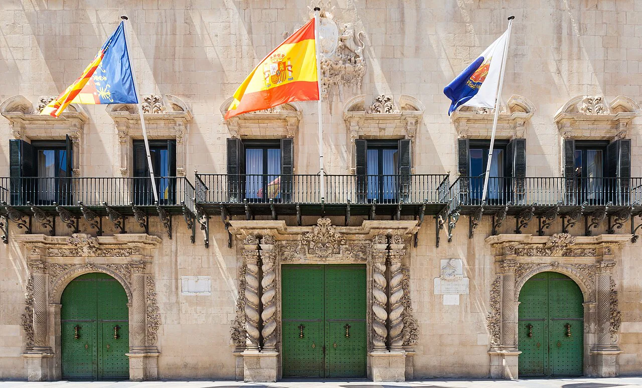Flags and doorways on the façade of Alicante Town Hall.