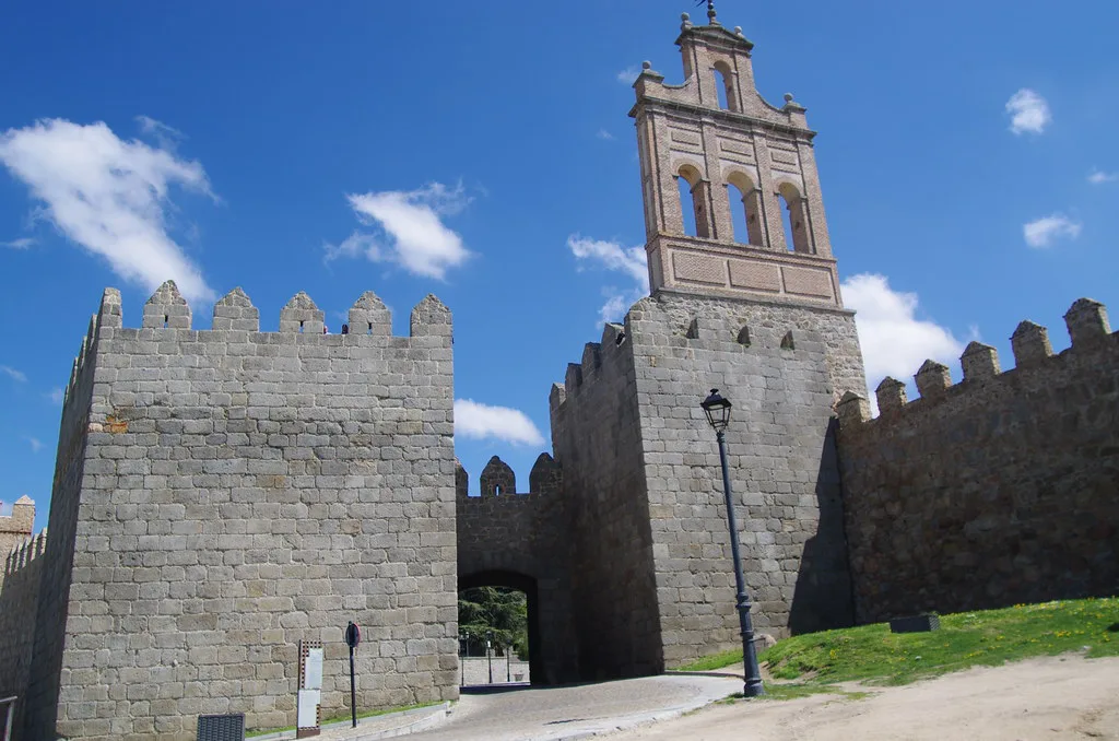 Ávila's medieval walls with a church bell tower beyond.