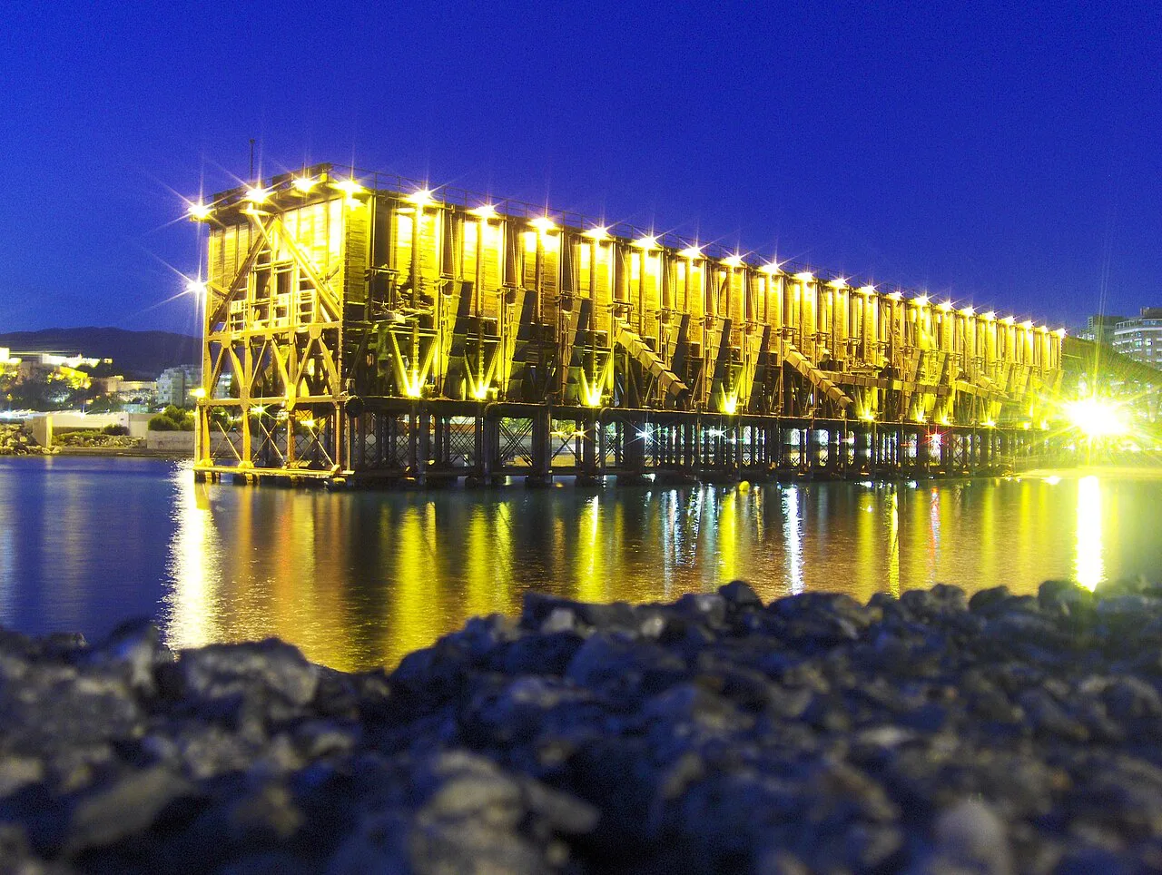 The Cable Inglés in Almería lit up at night, seen from the sea.