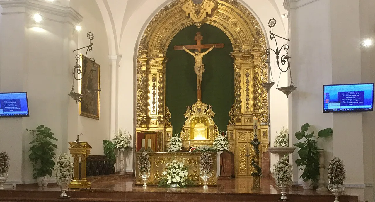 The gilded altarpiece and sanctuary inside the Iglesia de El Salvador, Nerja.