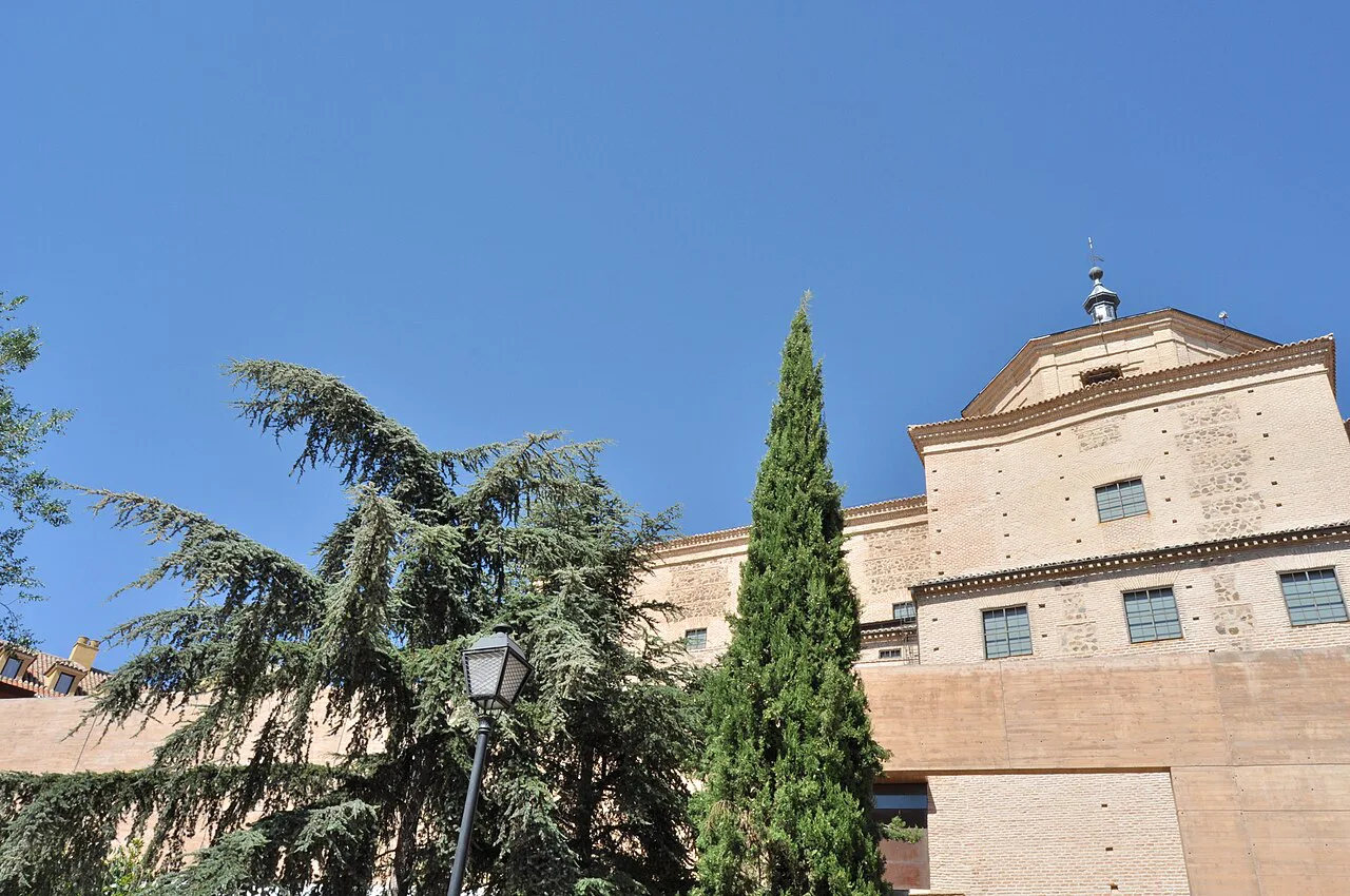 A church facade among trees in Toledo.
