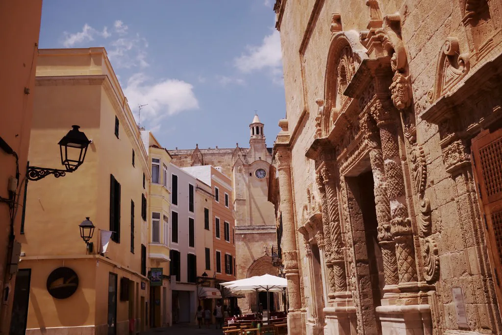 An old-town street with an ornate stone façade in Ciutadella de Menorca.