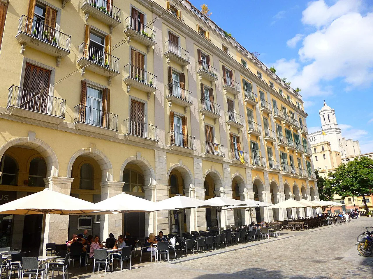 Café terraces under the arcades of Plaça de Sant Agustí (Plaça de la Independència), Girona.