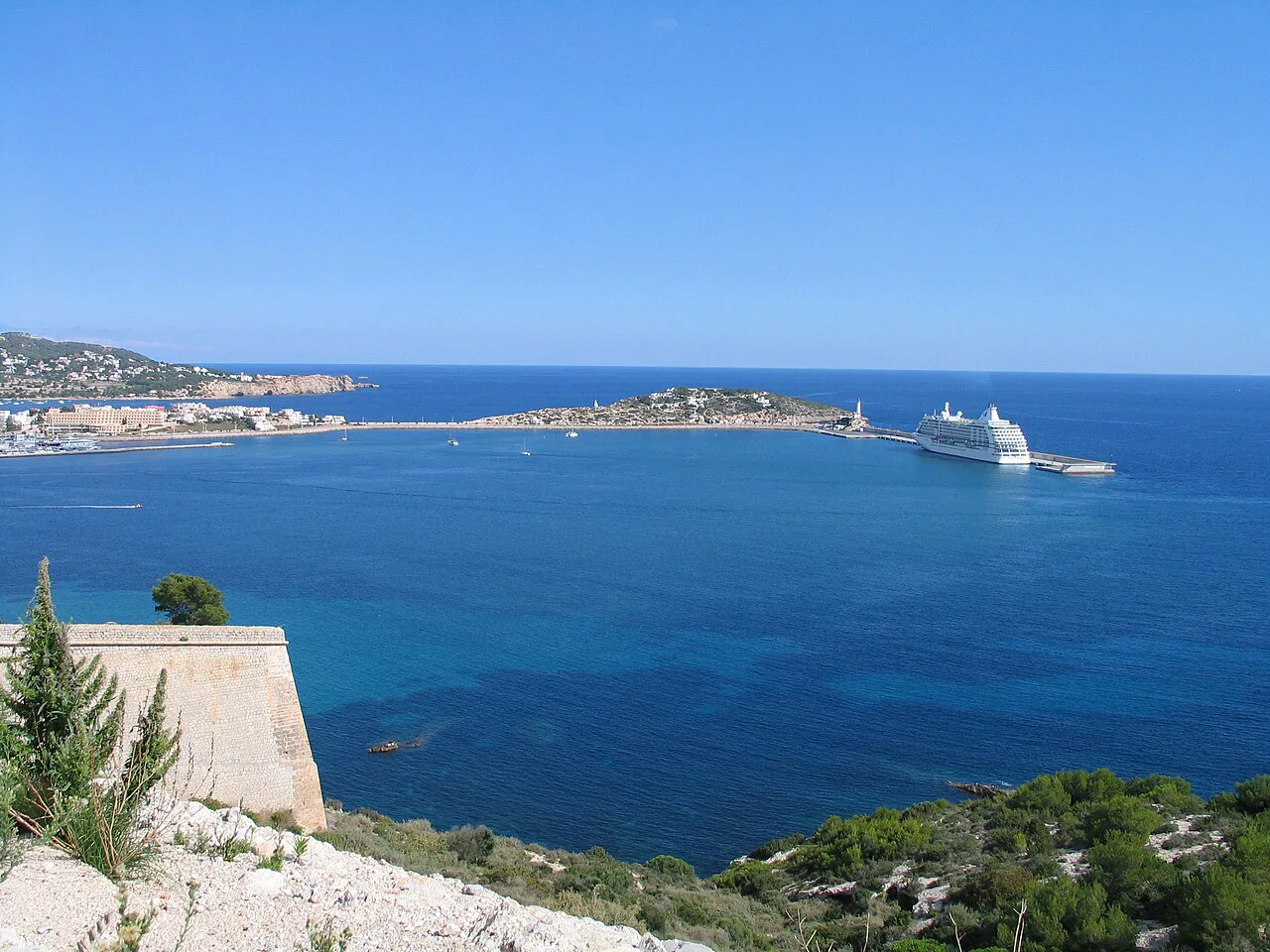 The sea and coastline seen from Ibiza Town, with a cruise ship offshore.