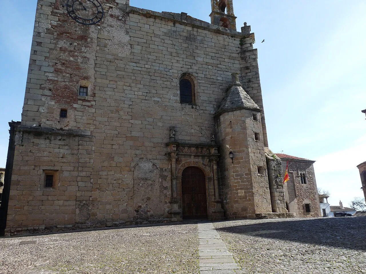 The stone façade and bell tower of the Church of San Mateo in Cáceres old town.