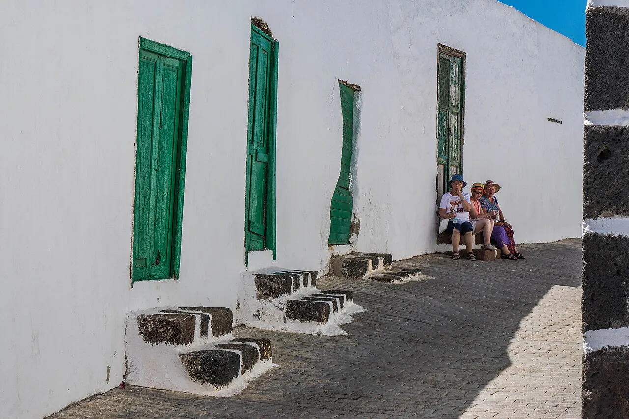 Whitewashed houses with green shutters on a street in Teguise, Lanzarote.