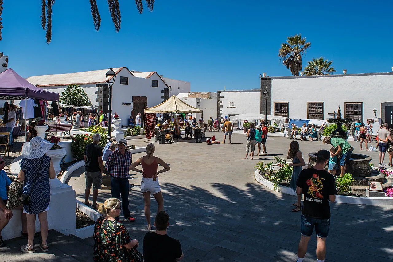 Market stalls and visitors in a square in Teguise, Lanzarote.