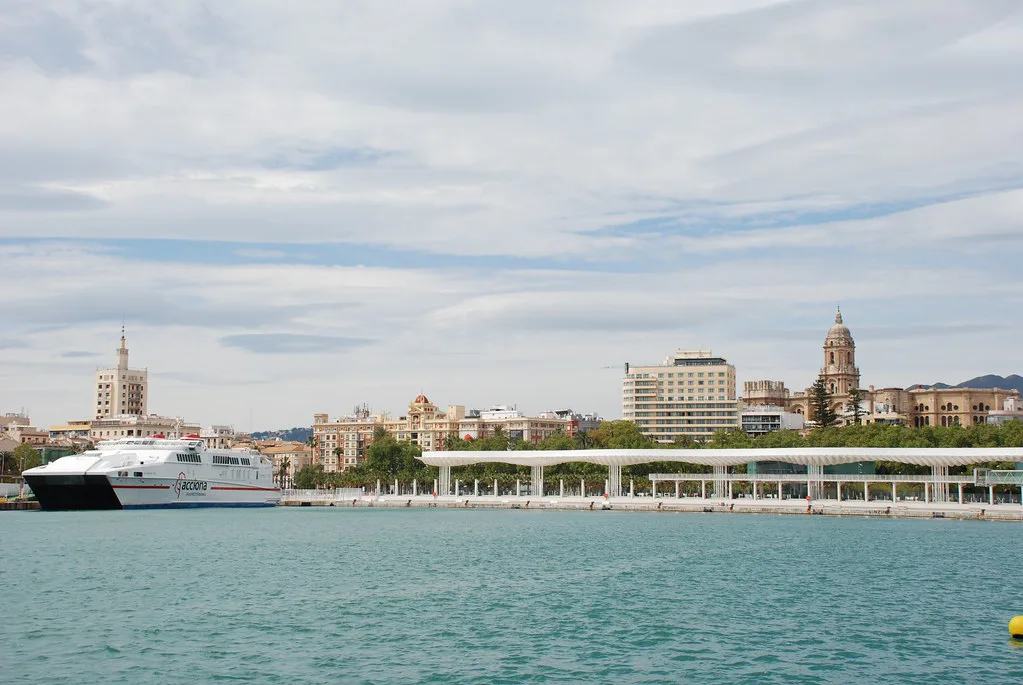 A ferry in Málaga port with the cathedral behind.