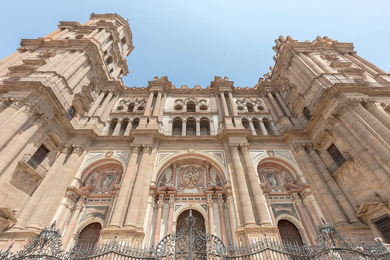 The Baroque main façade of Málaga Cathedral seen from below.