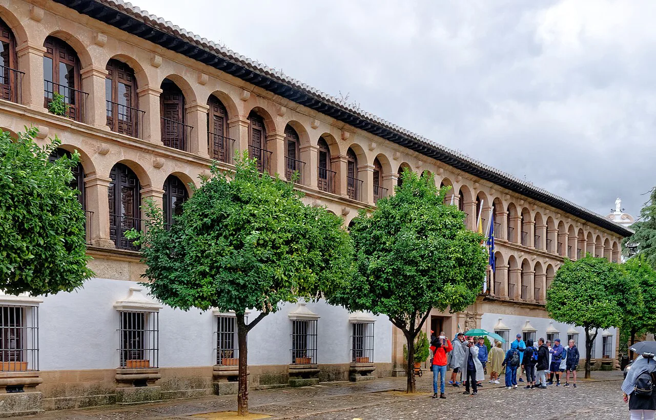 An arcaded historic building with visitors, Ronda.