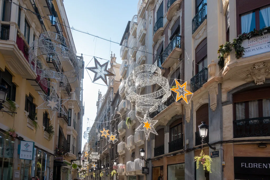 A shopping street in central Murcia hung with Christmas decorations.