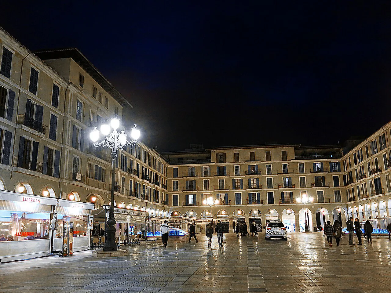 Plaça Major in Palma de Mallorca lit up at night.