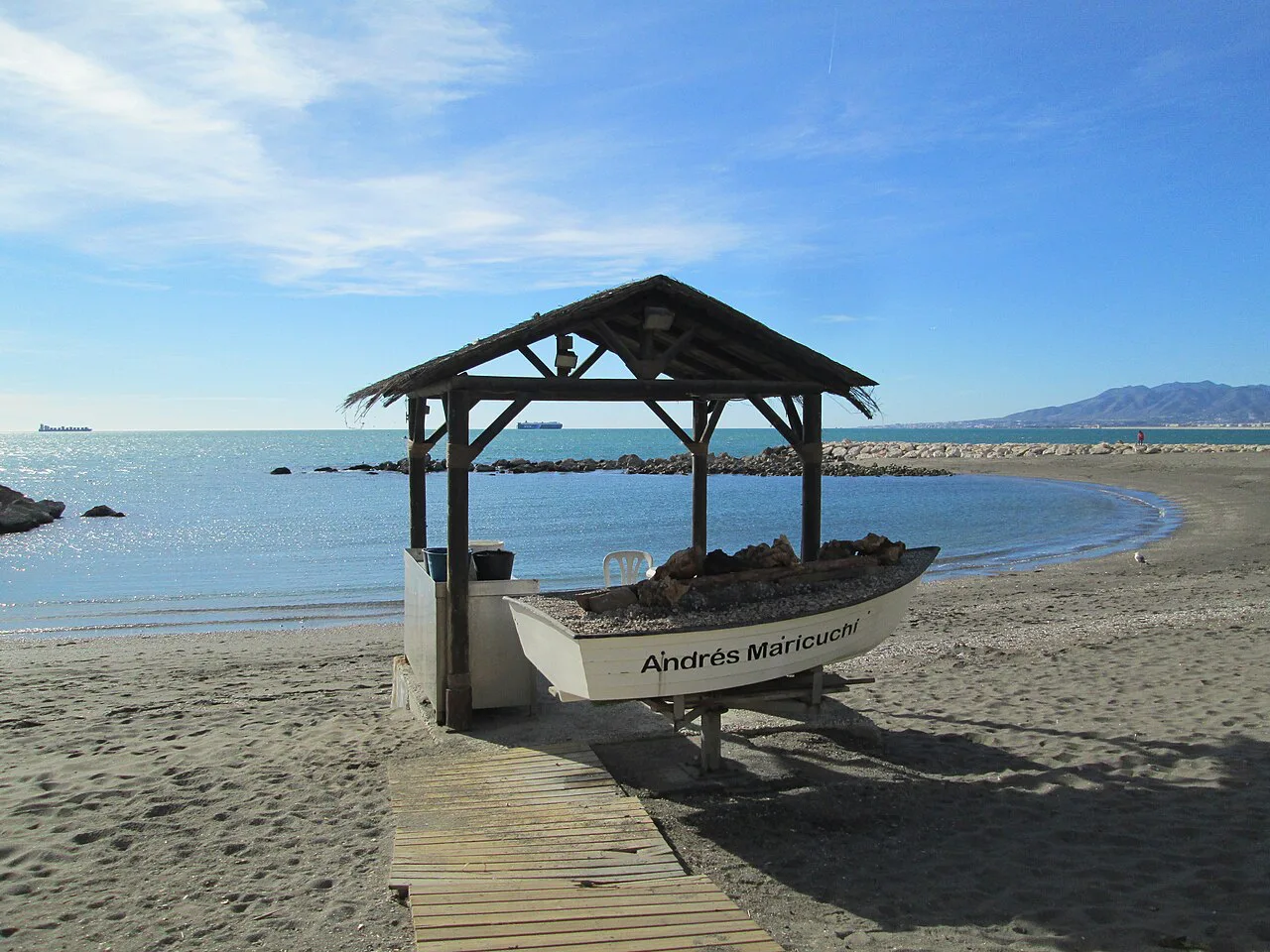 A fishing boat under a shelter on Pedregalejo beach, Málaga.