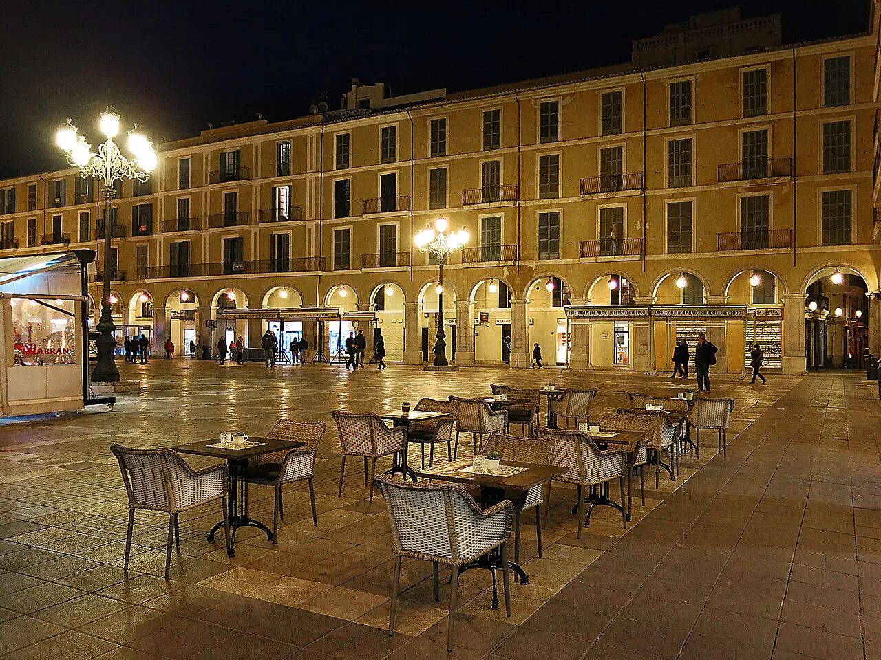 Café terraces on Plaça Major in Palma at night.