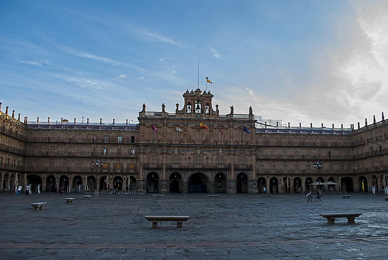 The empty Plaza Mayor of Salamanca under a blue sky.