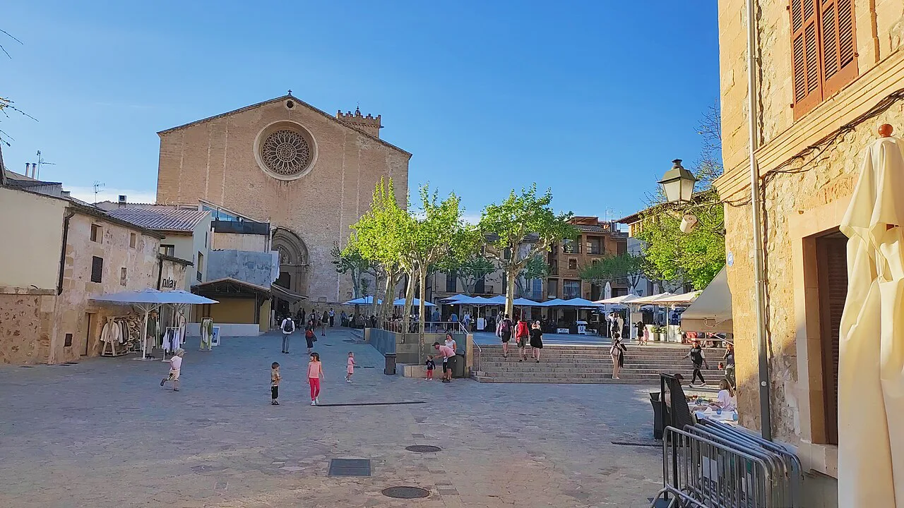 The main square and parish church of Pollença.