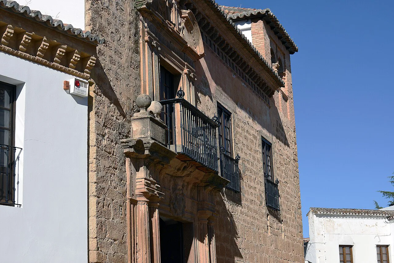 The stone façade and balcony of the Palacio de Mondragón in Ronda.