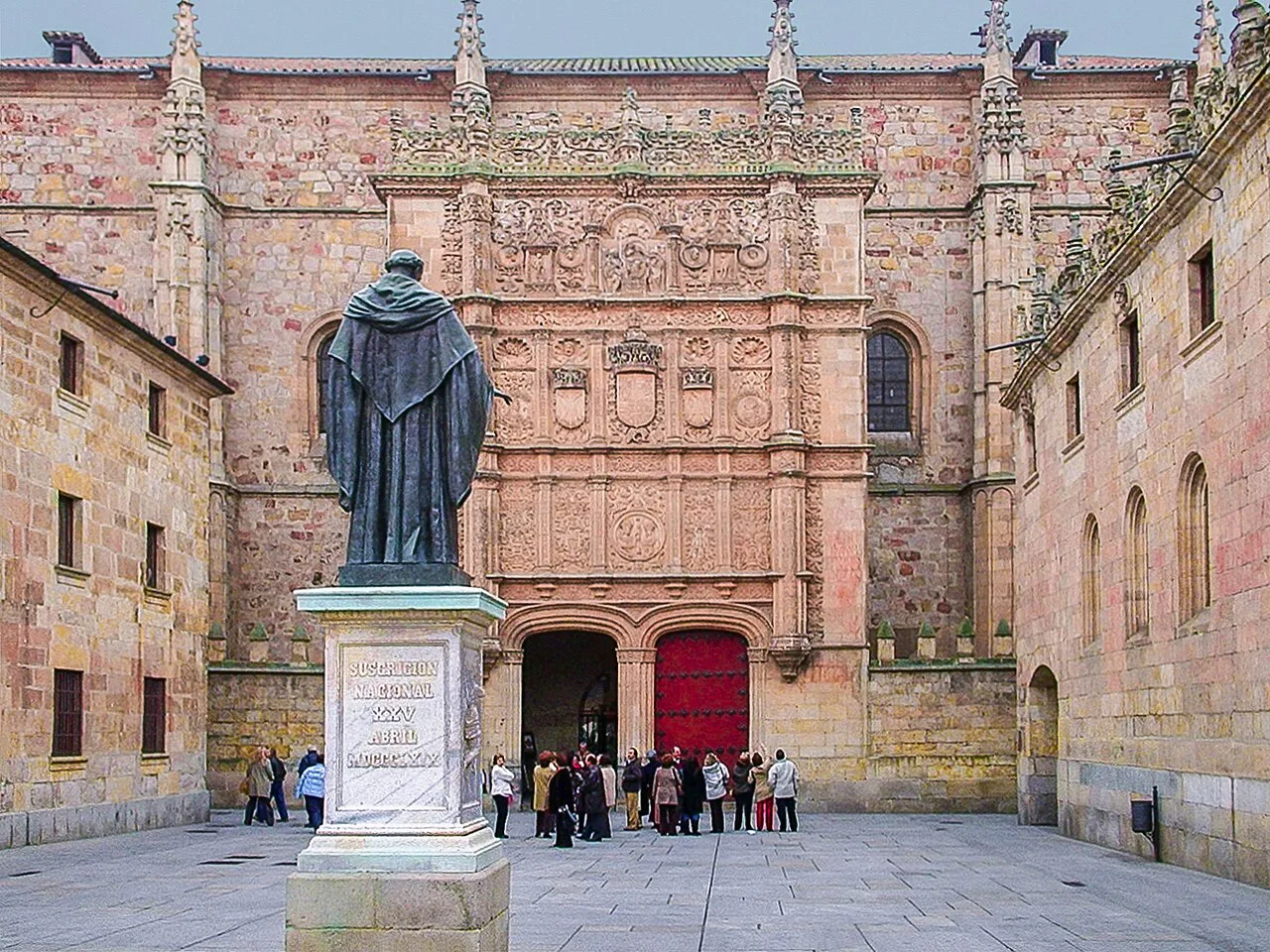 The statue of Fray Luis de León before the University of Salamanca façade.