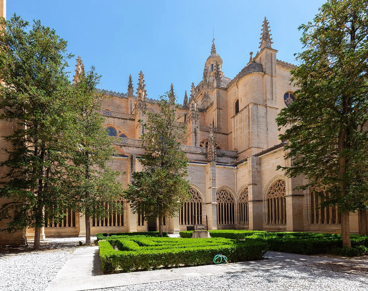 Segovia Cathedral above a garden courtyard.