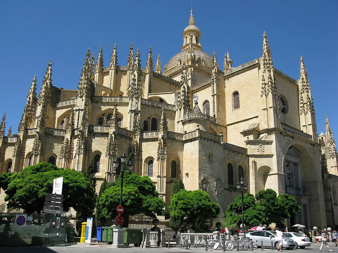 The Gothic Segovia Cathedral against a blue sky.