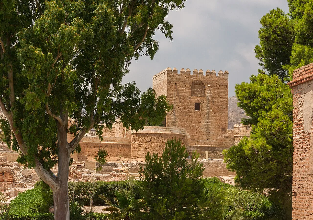 A tower of the Alcazaba of Almería among the gardens.