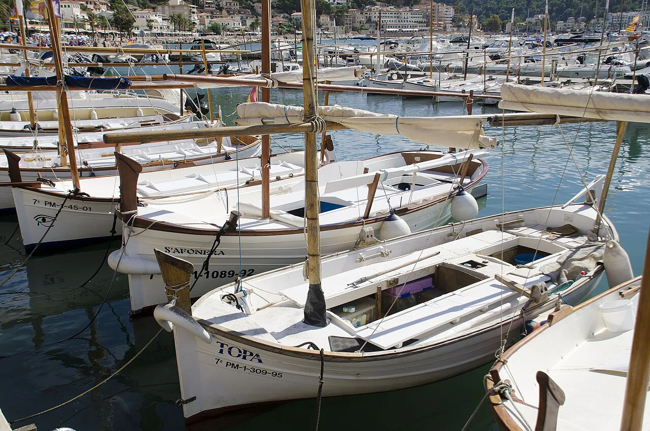 Small wooden boats moored in the harbour of Port de Sóller.