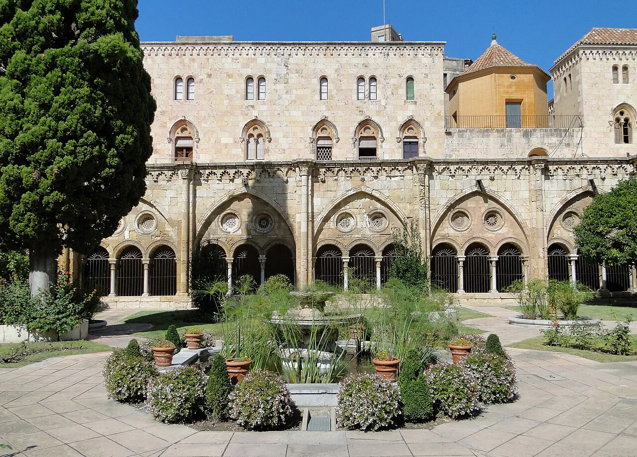 The cloister garden of Tarragona Cathedral, with the cathedral rising behind.