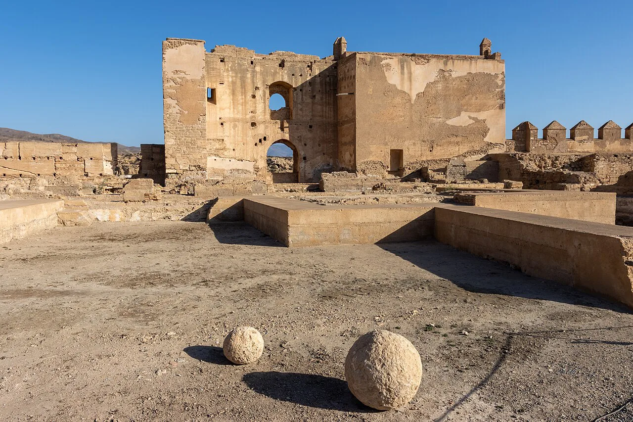 Ruined walls and stone cannonballs inside the Alcazaba of Almería.