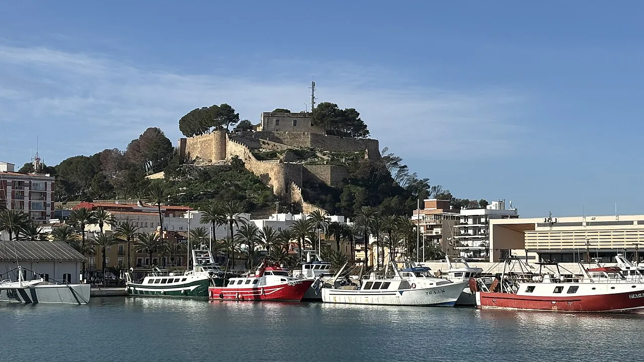 Dénia Castle above the harbour and fishing boats.
