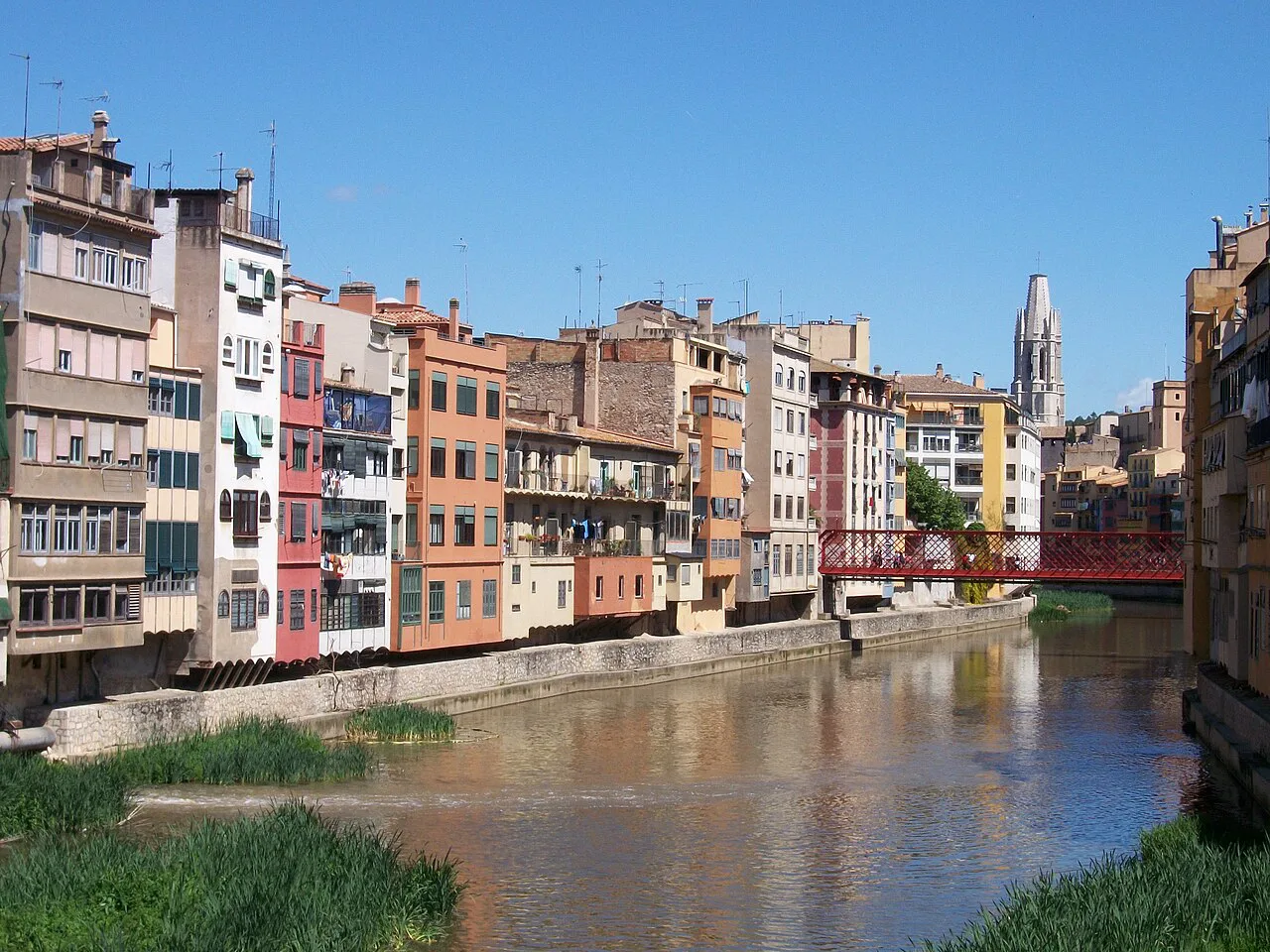 Colourful houses along the River Onyar and the Pont Eiffel in Girona.