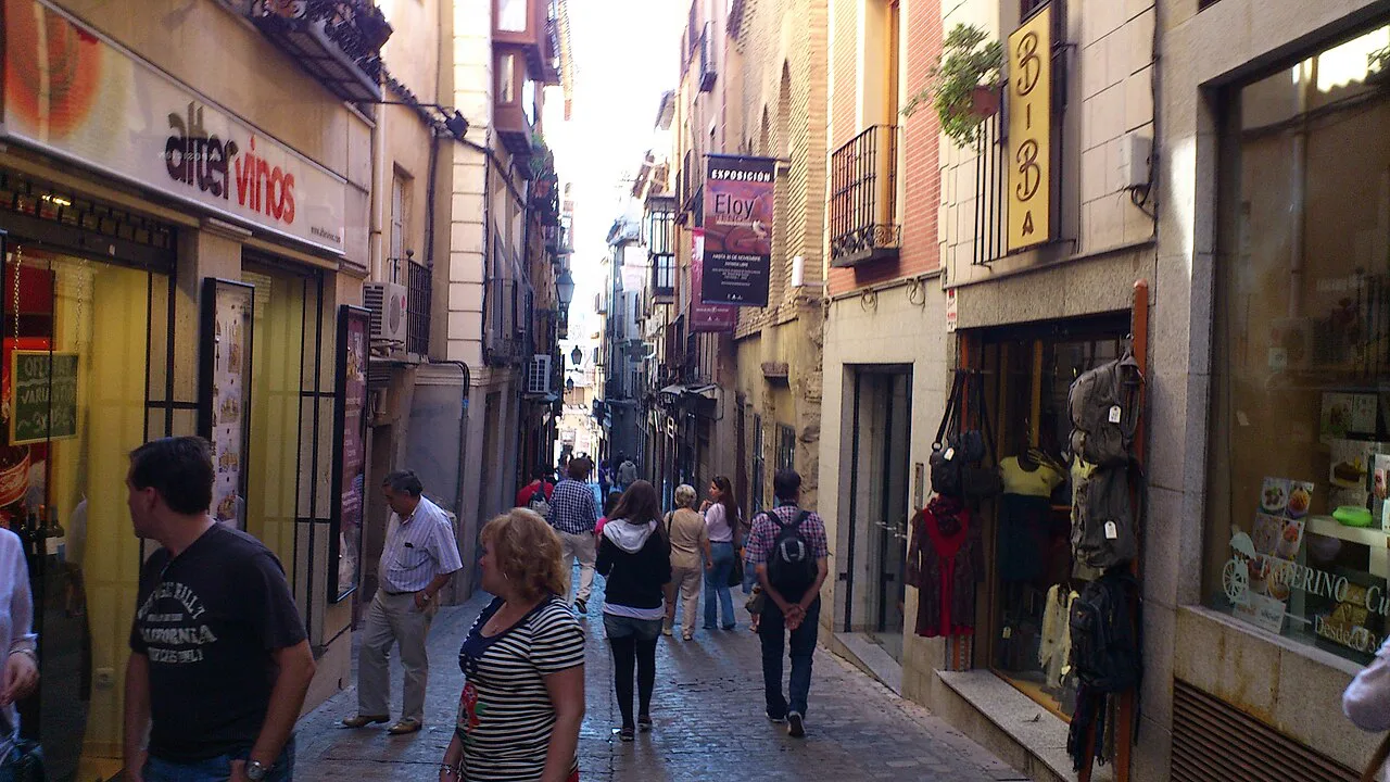 A narrow shopping street in the old town of Toledo.